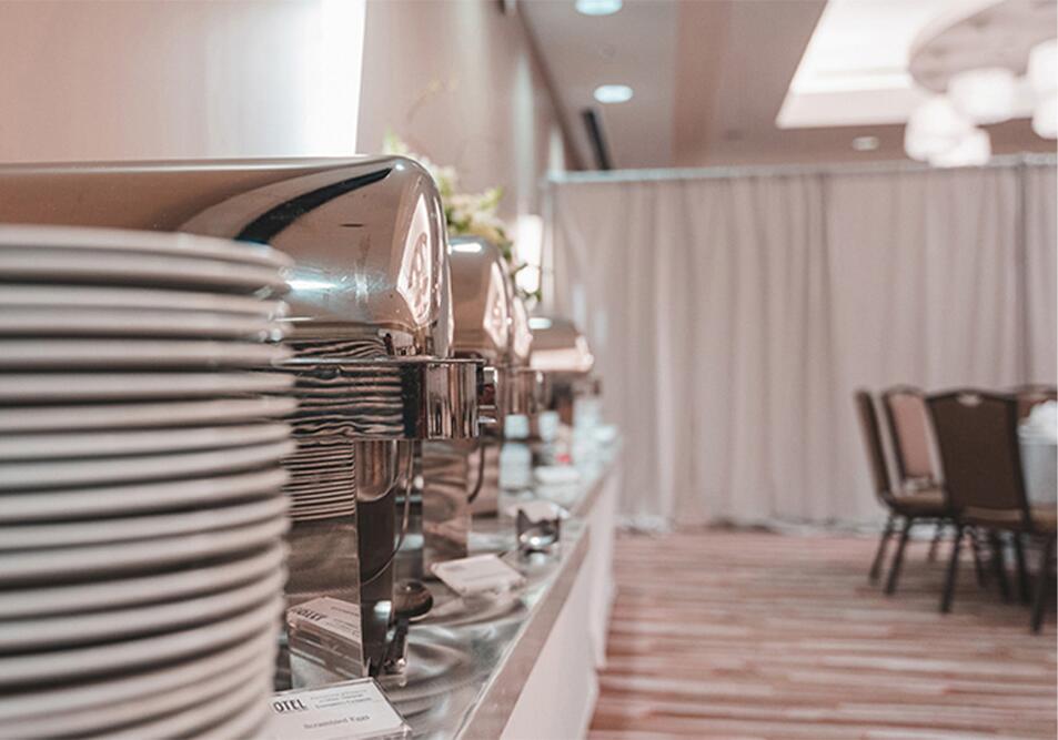 buffet service with plates and hot food containers